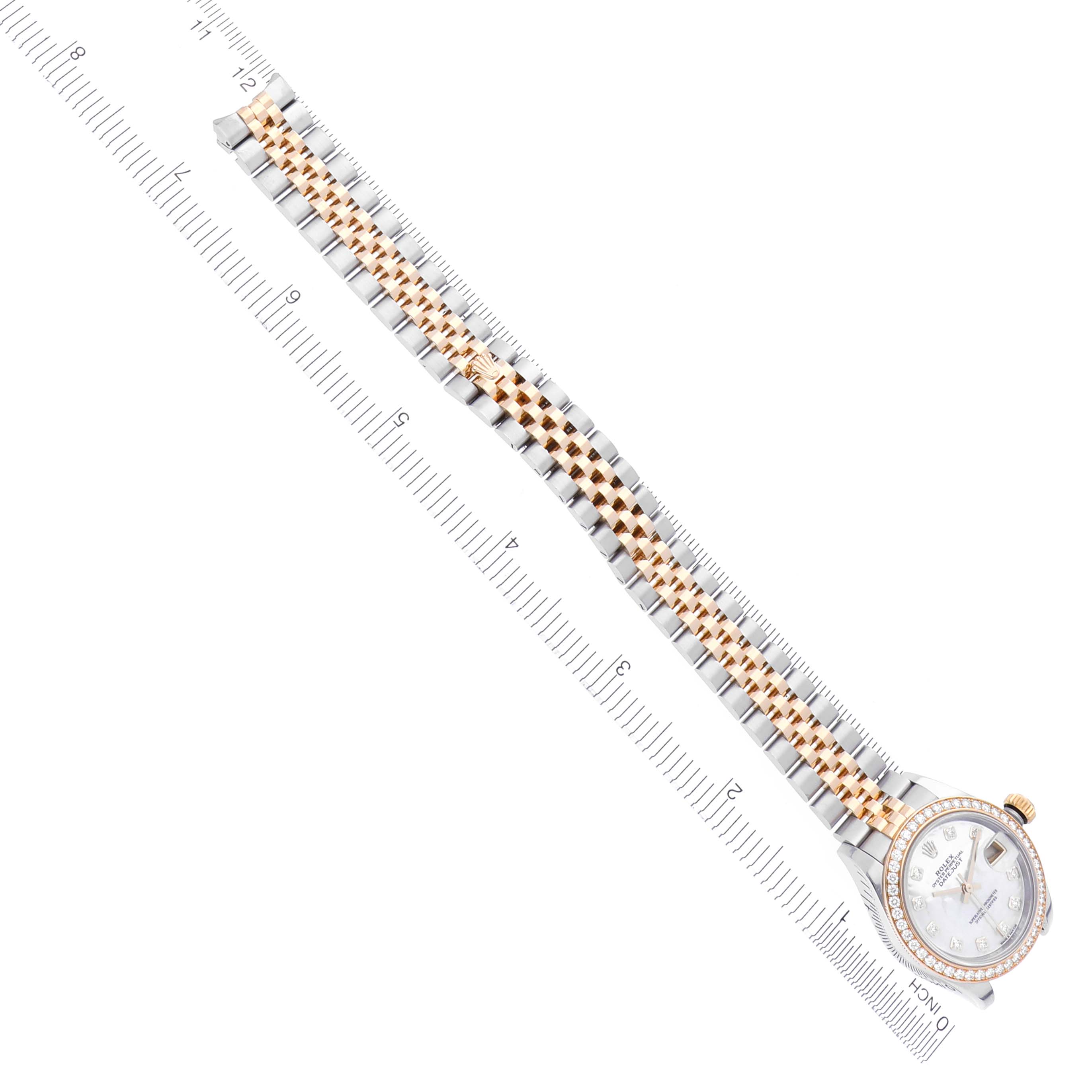 The Rolex Datejust 279383RBR Women's Steel and Gold (two tone) Mother of Pearl Dial 279383RBR Women's Steel and Gold (two tone) Mother of Pearl Dial watch is shown from a top-down angle, displaying the full bracelet and face alongside a ruler.