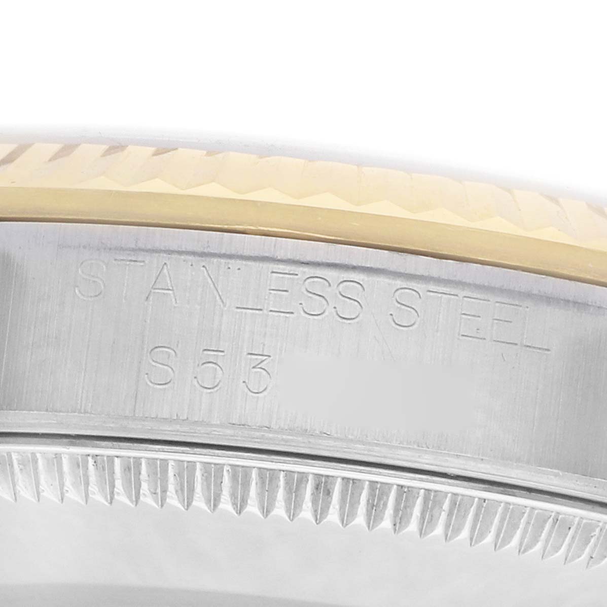 The image shows the stainless steel bezel and engraved details of a Rolex Mid-Size 68273 Women
s Steel and Gold (two tone) Silver Dial watch.