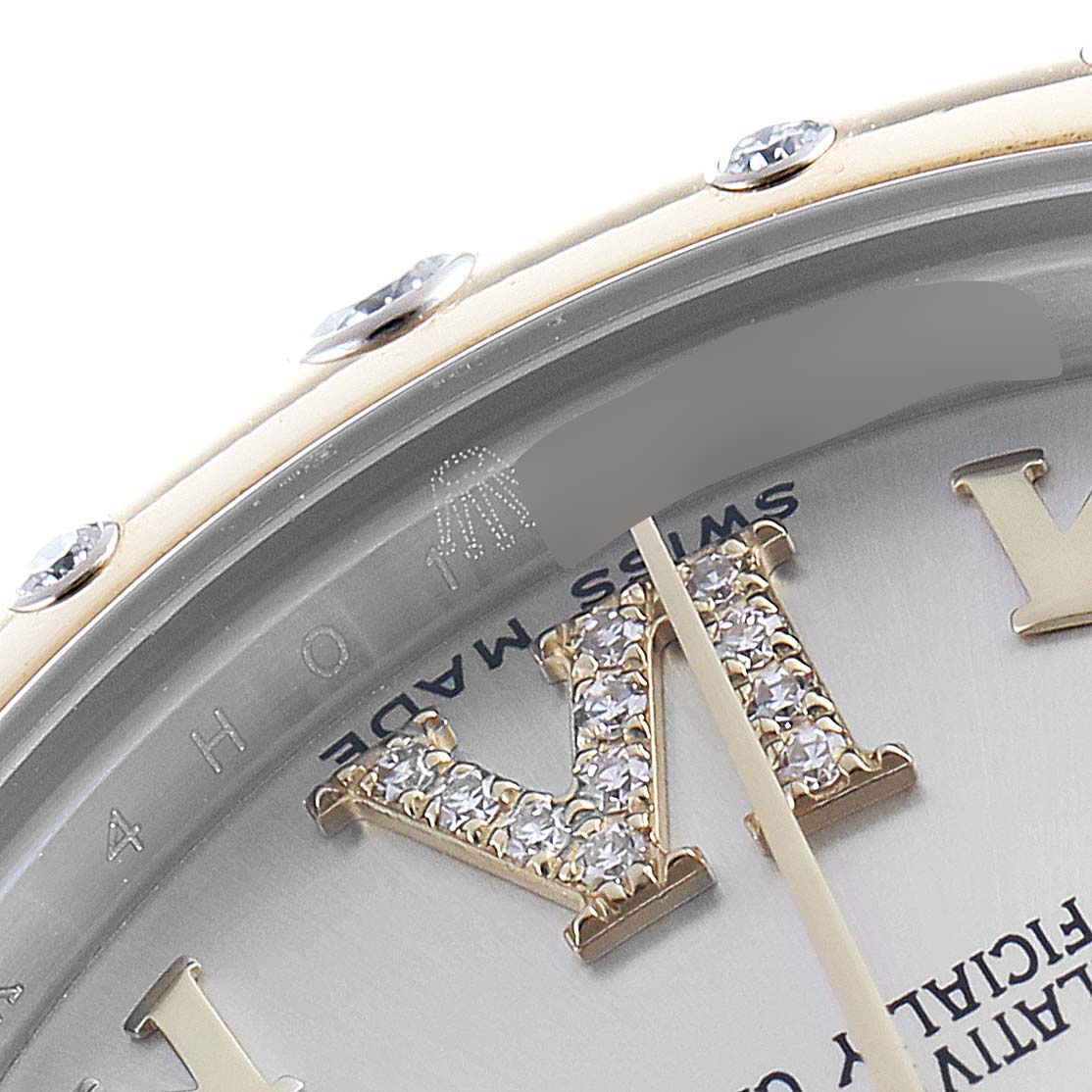 The image shows a partial close-up of the Rolex Mid-Size 178343 Women
s Steel and Gold (two tone) Silver Dial 178343 Women
s Steel and Gold (two tone) Silver Dial model watch face, focusing on the bezel and jeweled hour markers.