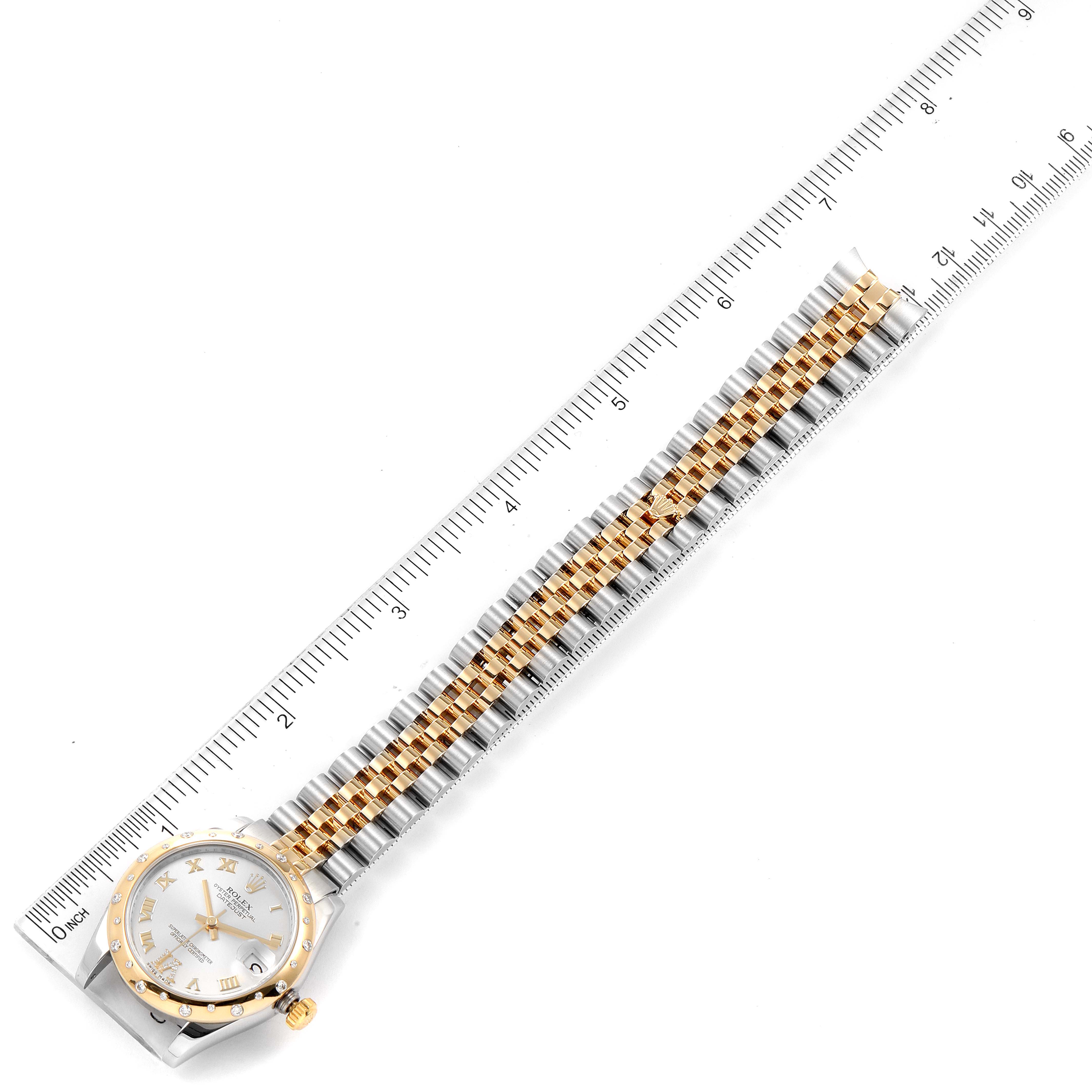 The image shows a Rolex Mid-Size 178343 Women
s Steel and Gold (two tone) Silver Dial 178343 Women
s Steel and Gold (two tone) Silver Dial watch from a top-down angle, highlighting its face, bezel, and gold-and-silver bracelet.