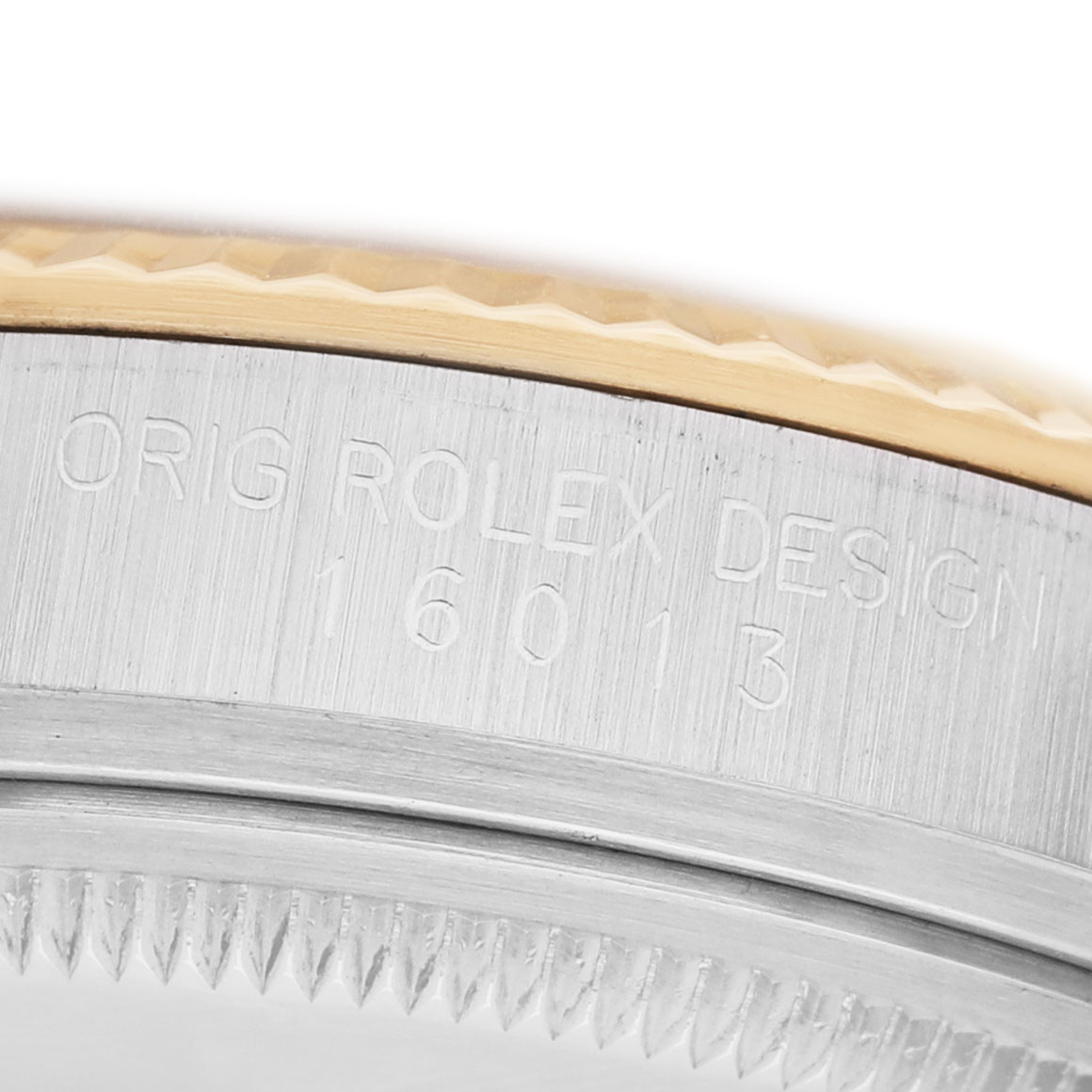 This image shows a close-up of the side of a Rolex Datejust 16013 Men's Steel and Gold (two tone) Champagne Dial, highlighting the bezel and engraved case numbers.