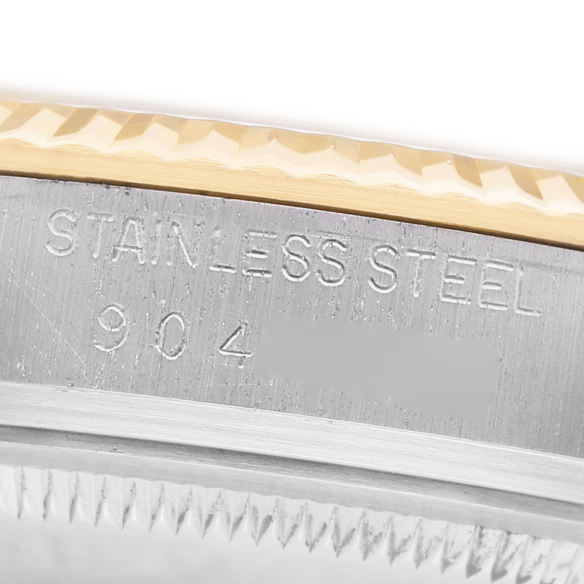 The image shows a close-up of the stainless steel edge and fluted bezel of a Rolex Datejust 16013 Men's Steel and Gold (two tone) Champagne Dial watch.