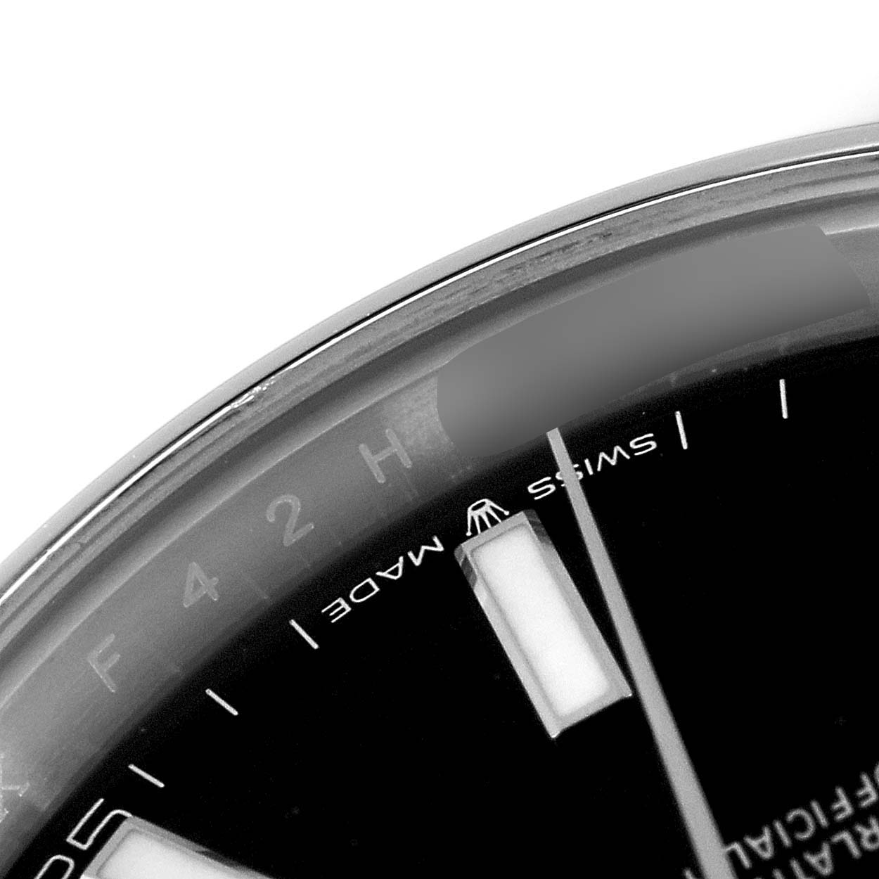 The image shows a close-up of the dial near the 12 o'clock position on a Rolex Datejust 41 126300 Men's Stainless Steel Black Dial 126300 Men's Stainless Steel Black Dial watch.