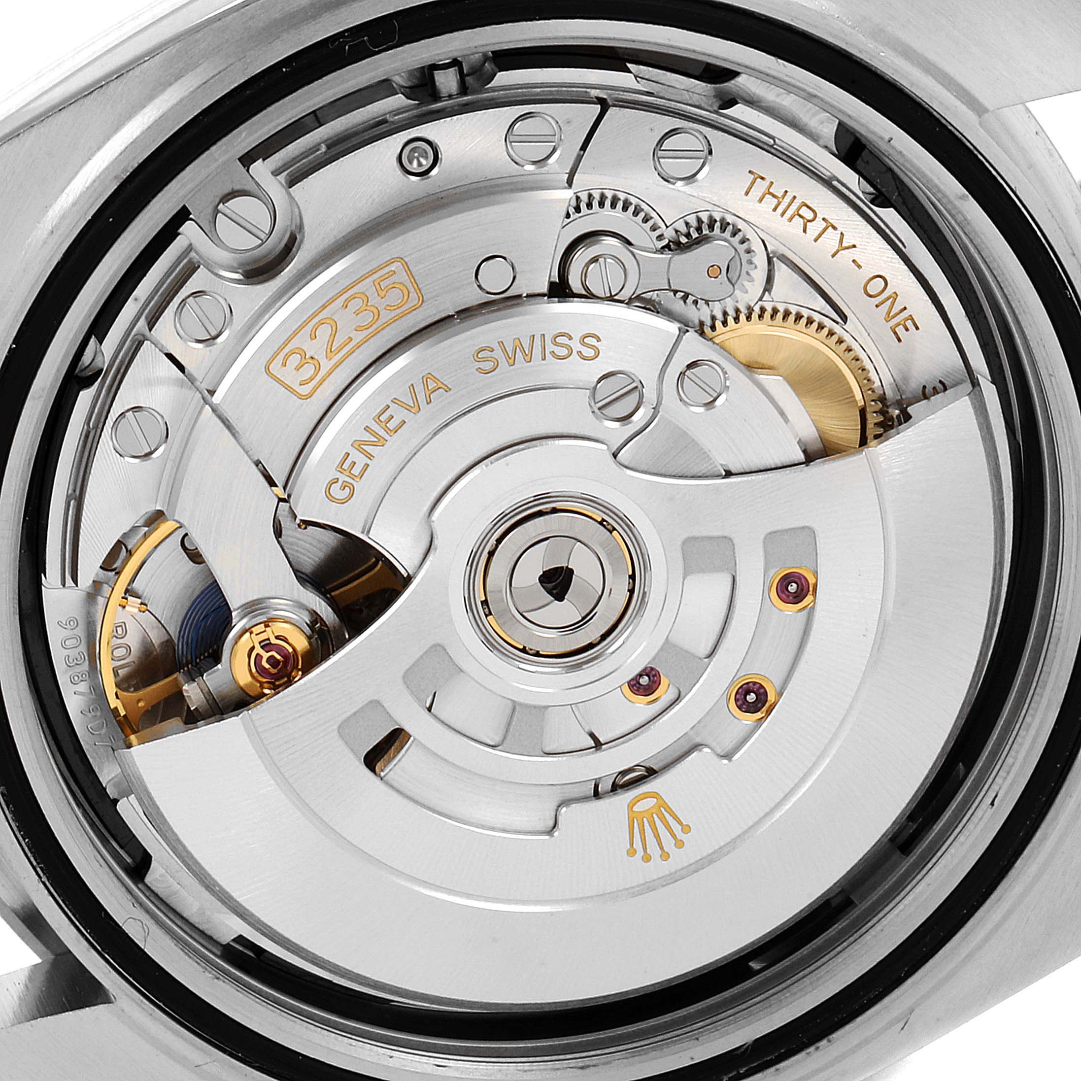 The image shows the movement mechanism of the Rolex Datejust 41 126300 Men's Stainless Steel Black Dial 126300 Men's Stainless Steel Black Dial watch, highlighting its intricate gears and components.