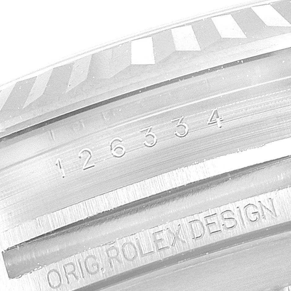 This close-up image of the Rolex Datejust 41 126334 Men
s Stainless Steel White Dial 126334 Men
s Stainless Steel White Dial model shows the serial number and "ORIG. ROLEX DESIGN" inscription on the case.