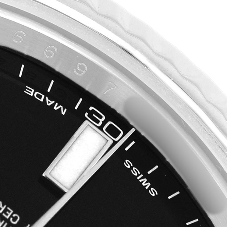 The image shows a close-up of the dial of a Rolex Datejust 41 116334 Men's Stainless Steel Black Dial, featuring the date window and part of the bezel.
