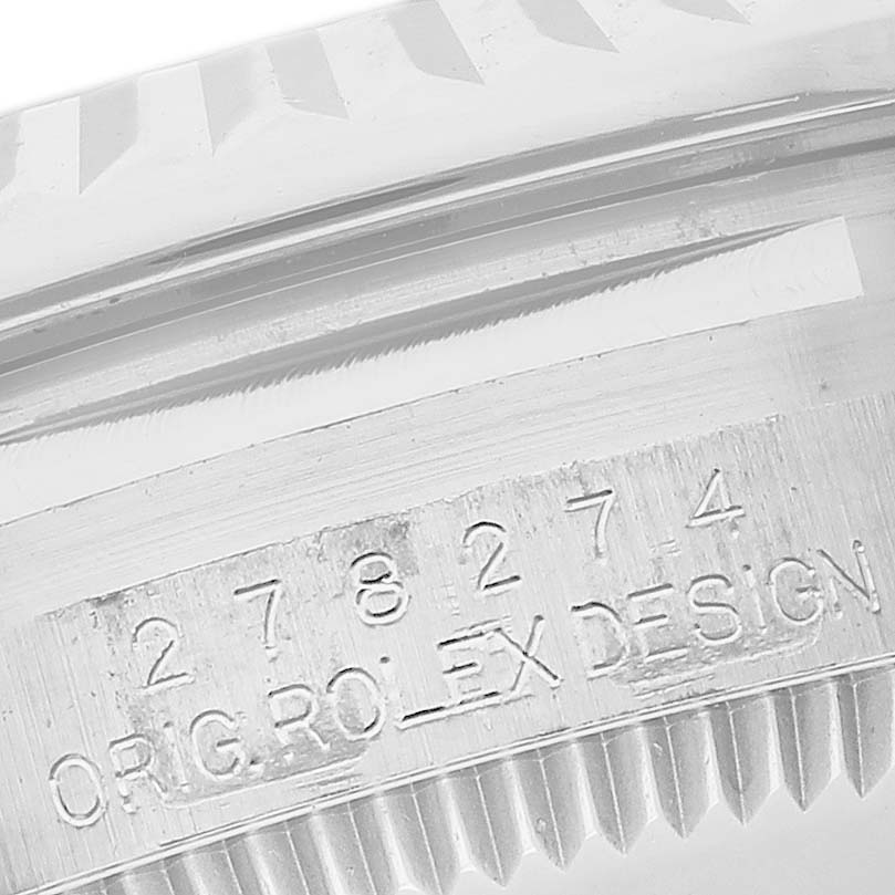 The image shows the side engraving on the bezel of a Mid-Size Rolex watch.