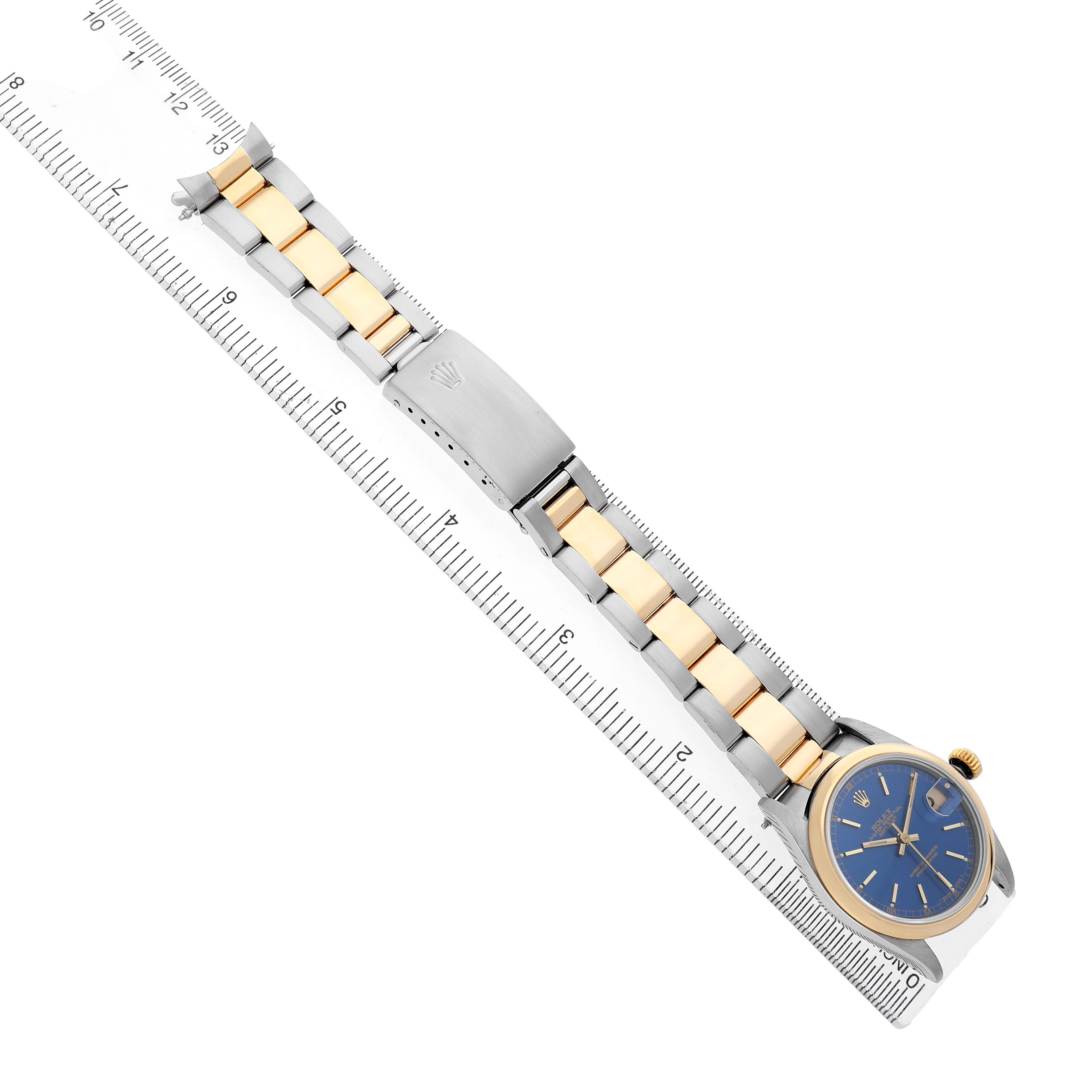 The Rolex Datejust 68243 Women's Steel and Gold (two tone) Blue Dial watch is shown at an oblique angle, highlighting the bracelet, clasp, and dial.
