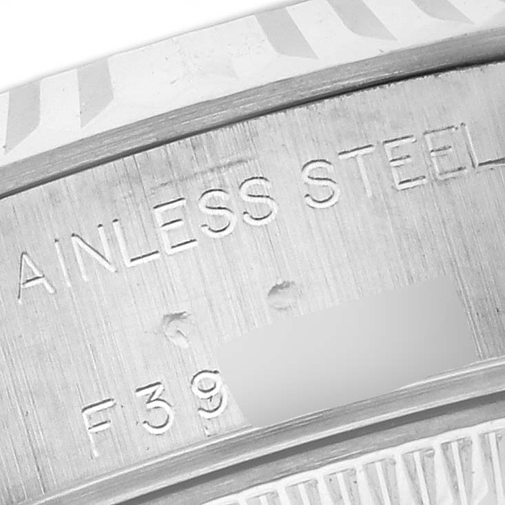 The image shows a close-up of the Rolex Datejust 79174 Women's Stainless Steel Silver Dial 79174 Women's Stainless Steel Silver Dial model's stainless steel casing with engravings.