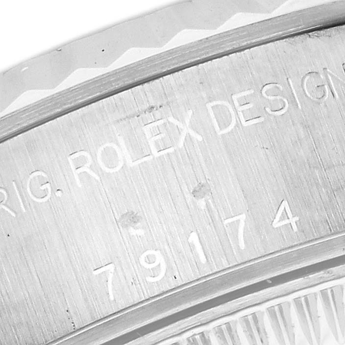 The image shows a close-up of the serial number and engraving on the case back of a Rolex Datejust 79174 Women's Stainless Steel Silver Dial 79174 Women's Stainless Steel Silver Dial watch.