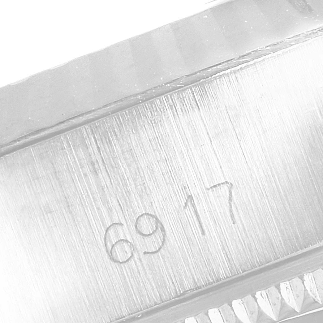 This close-up image shows part of the casing with the model number "6917" engraved on a Rolex Datejust 6917 Women's Stainless Steel Silver Dial 6917 Women's Stainless Steel Silver Dial watch.