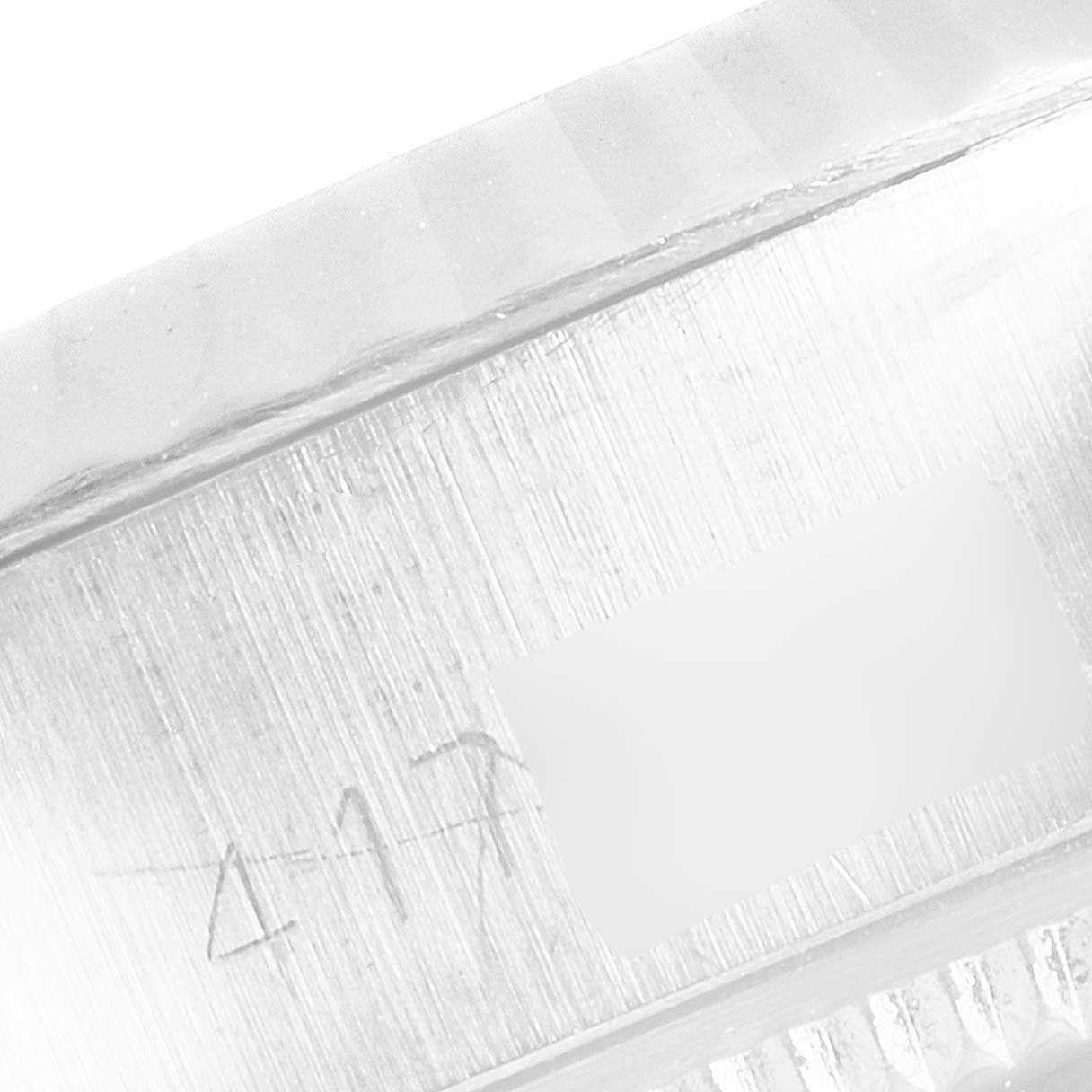 This is a close-up shot of the engravings on the side of the bezel of a Rolex Datejust 6917 Women's Stainless Steel Silver Dial 6917 Women's Stainless Steel Silver Dial watch.
