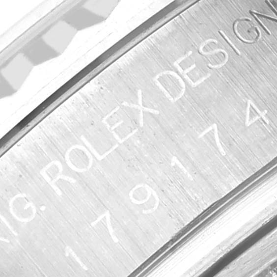 The image shows a close-up of the inner bezel engraving on a Rolex Datejust 179174 Women's Stainless Steel Mother of Pearl Dial 179174 Women's Stainless Steel Mother of Pearl Dial watch.