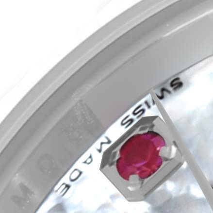 Close-up of a Rolex Datejust 179174 Women's Stainless Steel Mother of Pearl Dial 179174 Women's Stainless Steel Mother of Pearl Dial watch, showing a red gem and part of the “SWISS MADE” text on the dial edge.