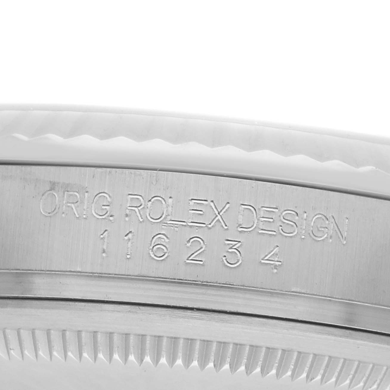 The image shows a close-up view of the side of a Rolex Datejust 116234 Men
s Stainless Steel Silver Dial watch case, featuring engraved text and part of the bezel.
