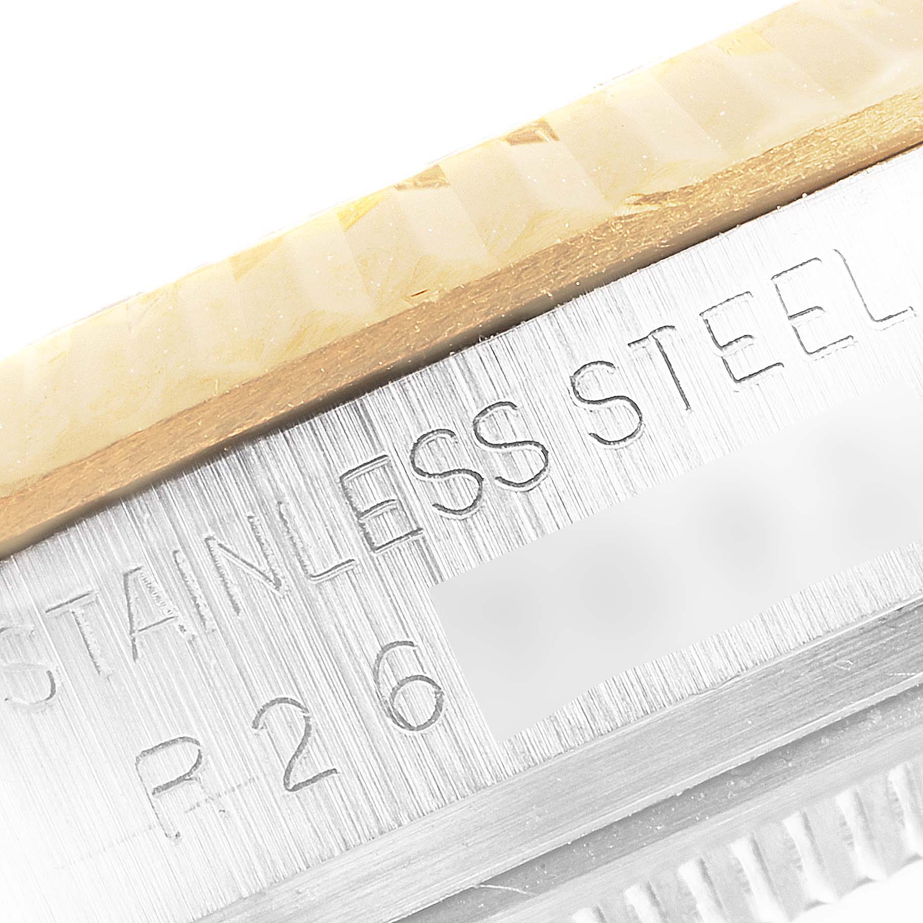 The image shows a close-up of the bezel and case of a Rolex Datejust 16013 Men's Steel and Gold (two tone) Black Dial 16013 Men's Steel and Gold (two tone) Black Dial watch with engraving visible.