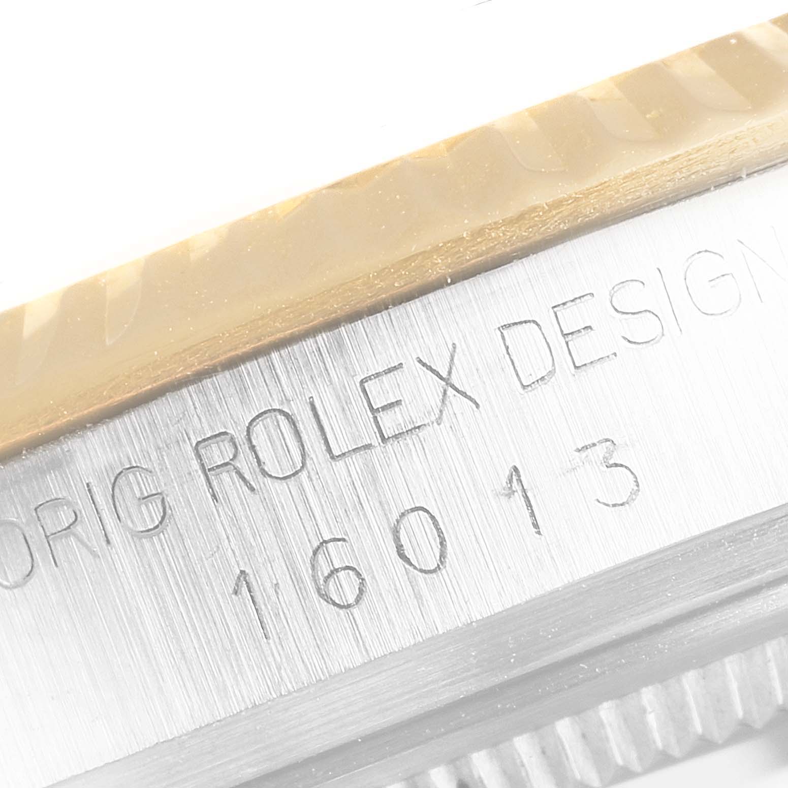 This close-up image shows the side bezel and engraved case of a Rolex Datejust 16013 Men's Steel and Gold (two tone) Black Dial 16013 Men's Steel and Gold (two tone) Black Dial model, revealing the serial and reference numbers.