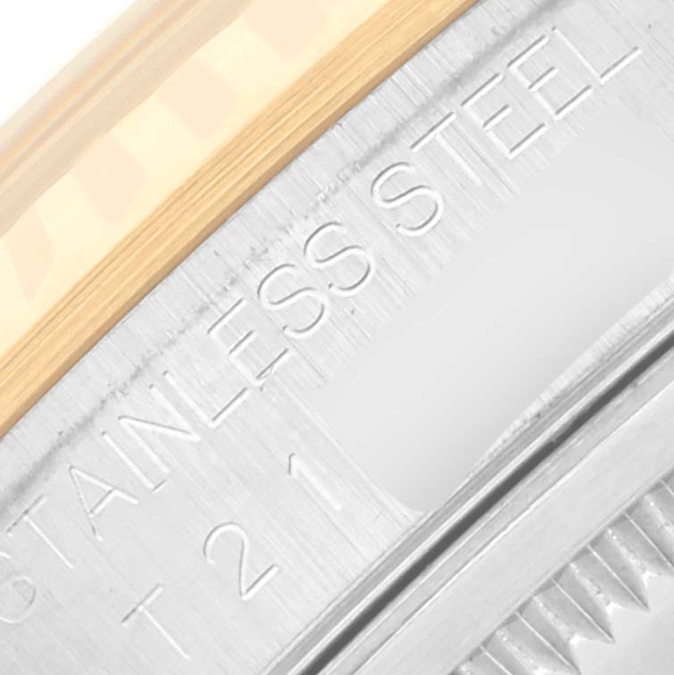 The image shows a close-up of the Rolex Datejust 16233 Men's Steel and Gold (two tone) Black Dial 16233 Men's Steel and Gold (two tone) Black Dial's bezel and part of the steel casing, featuring "STAINLESS STEEL" engraving.