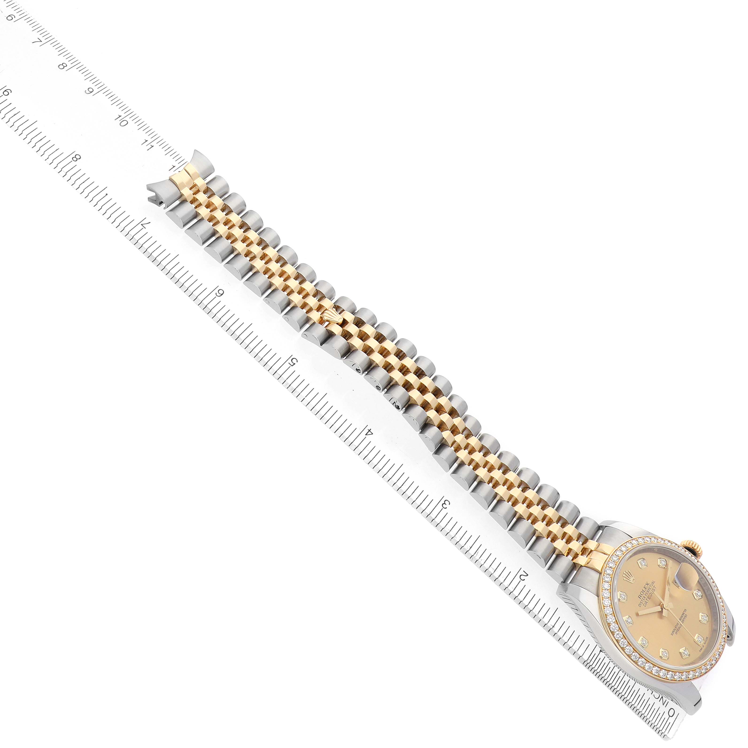 The Rolex Datejust 116243 Men
s Steel and Gold (two tone) Champagne Dial watch is shown from a side angle, displaying the bracelet, bezel, and partially the watch face.