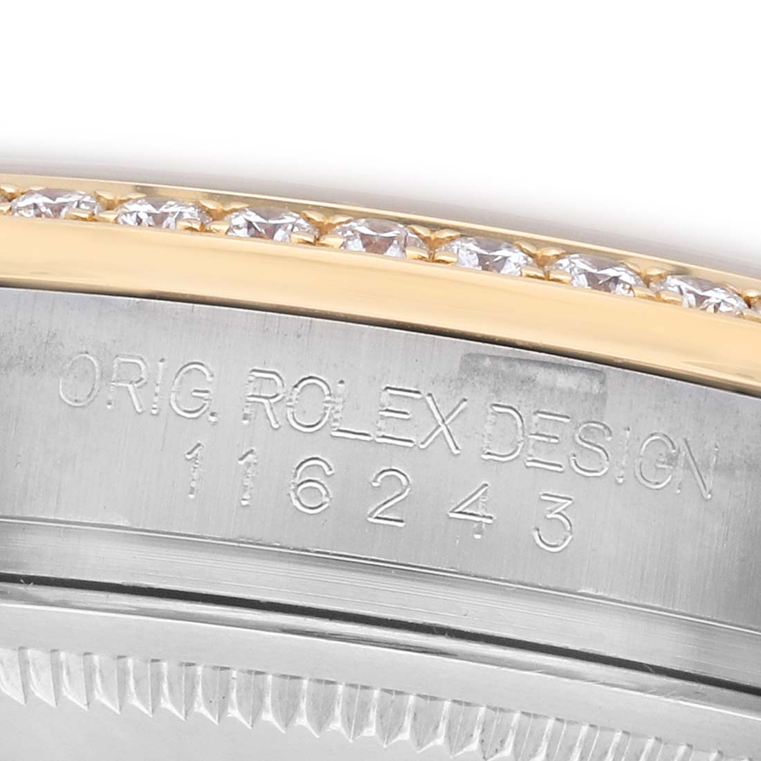 The image shows a close-up of the Rolex Datejust 116243 Men
s Steel and Gold (two tone) Champagne Dial model
s engraved case side and diamond-studded bezel.