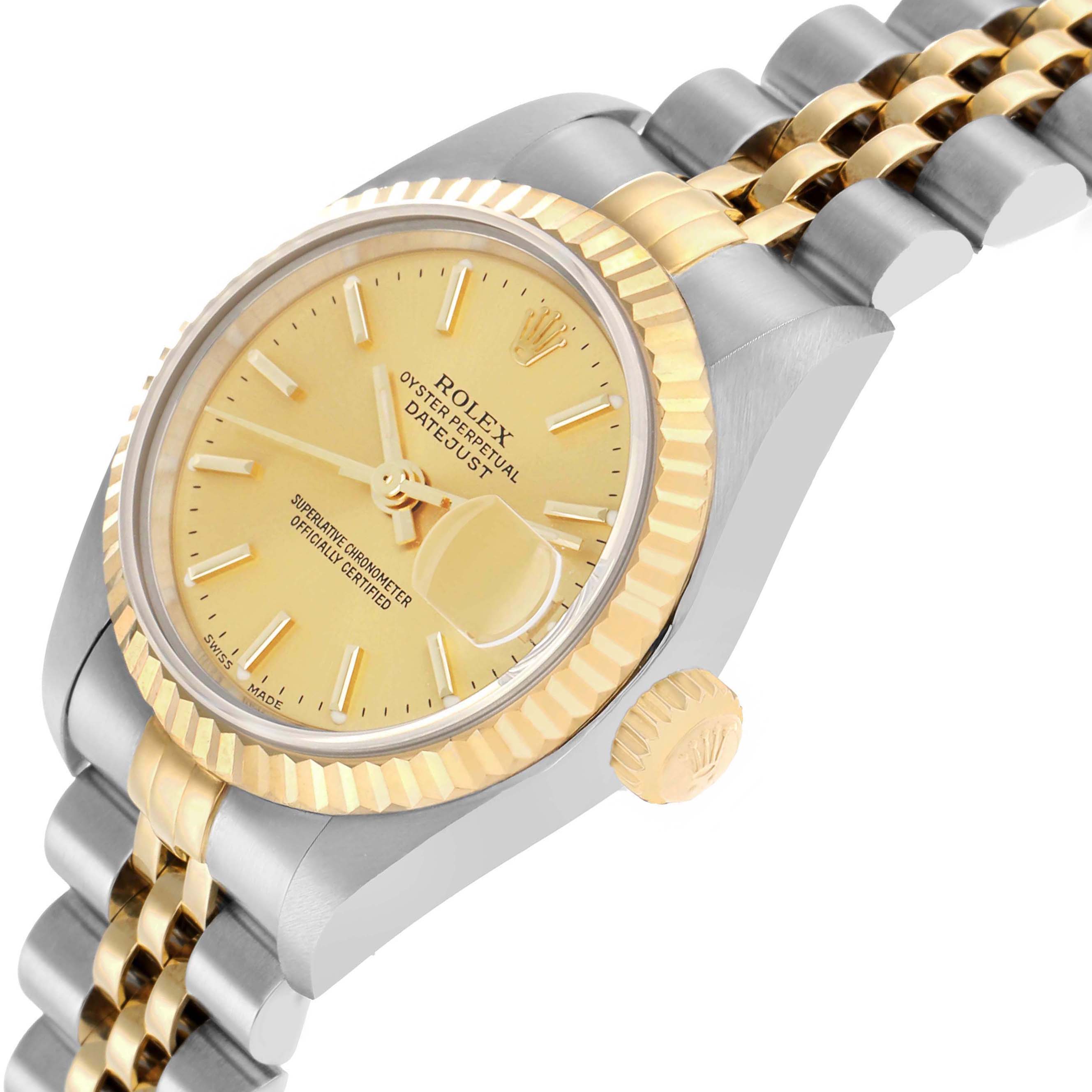 The Rolex Datejust 79173 Women
s Steel and Gold (two tone) Champagne Dial watch is shown from a side angle, highlighting its gold-toned dial, fluted bezel, and two-tone bracelet.