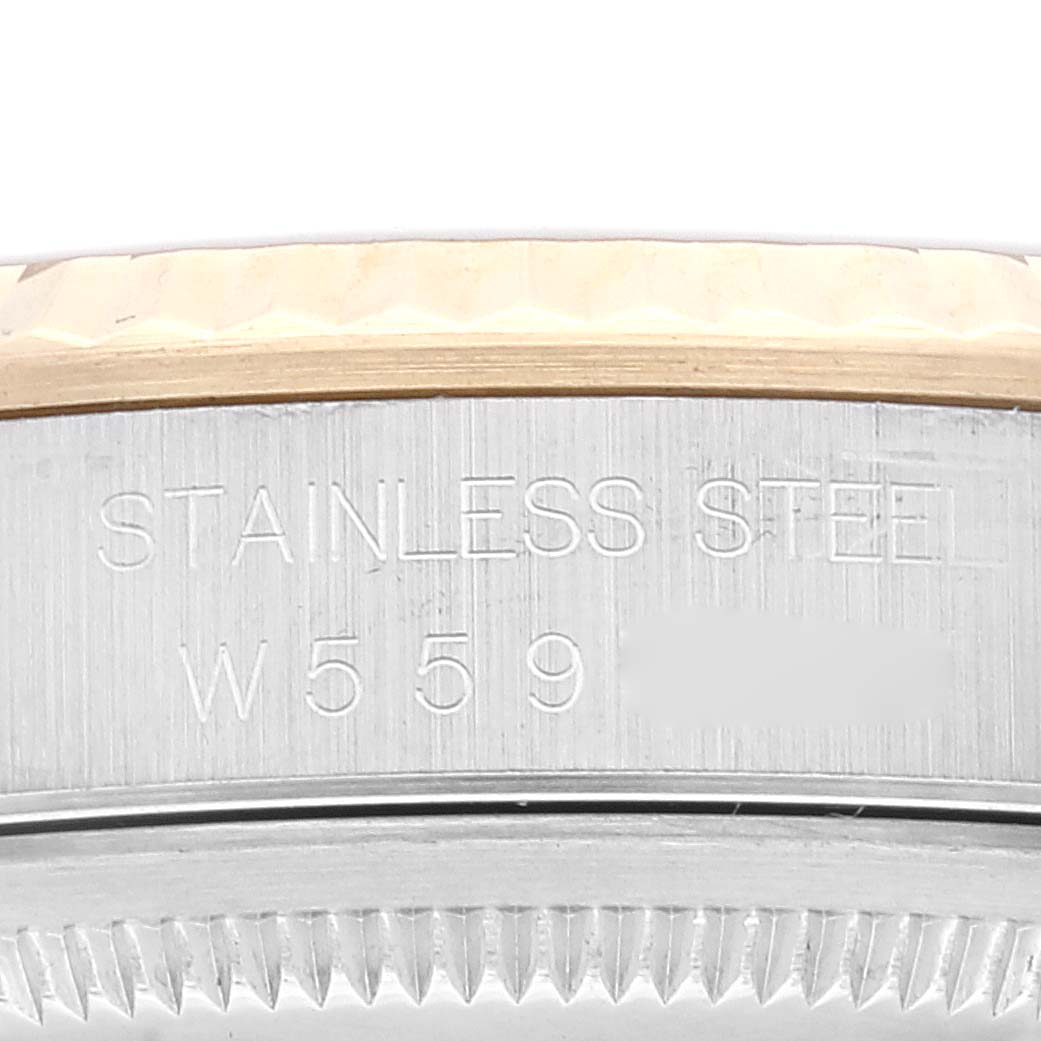 This image shows the side of the Rolex Datejust 16233 Men's Steel and Gold (two tone) Champagne Dial 16233 Men's Steel and Gold (two tone) Champagne Dial, featuring the stainless steel case and a portion of the fluted bezel.