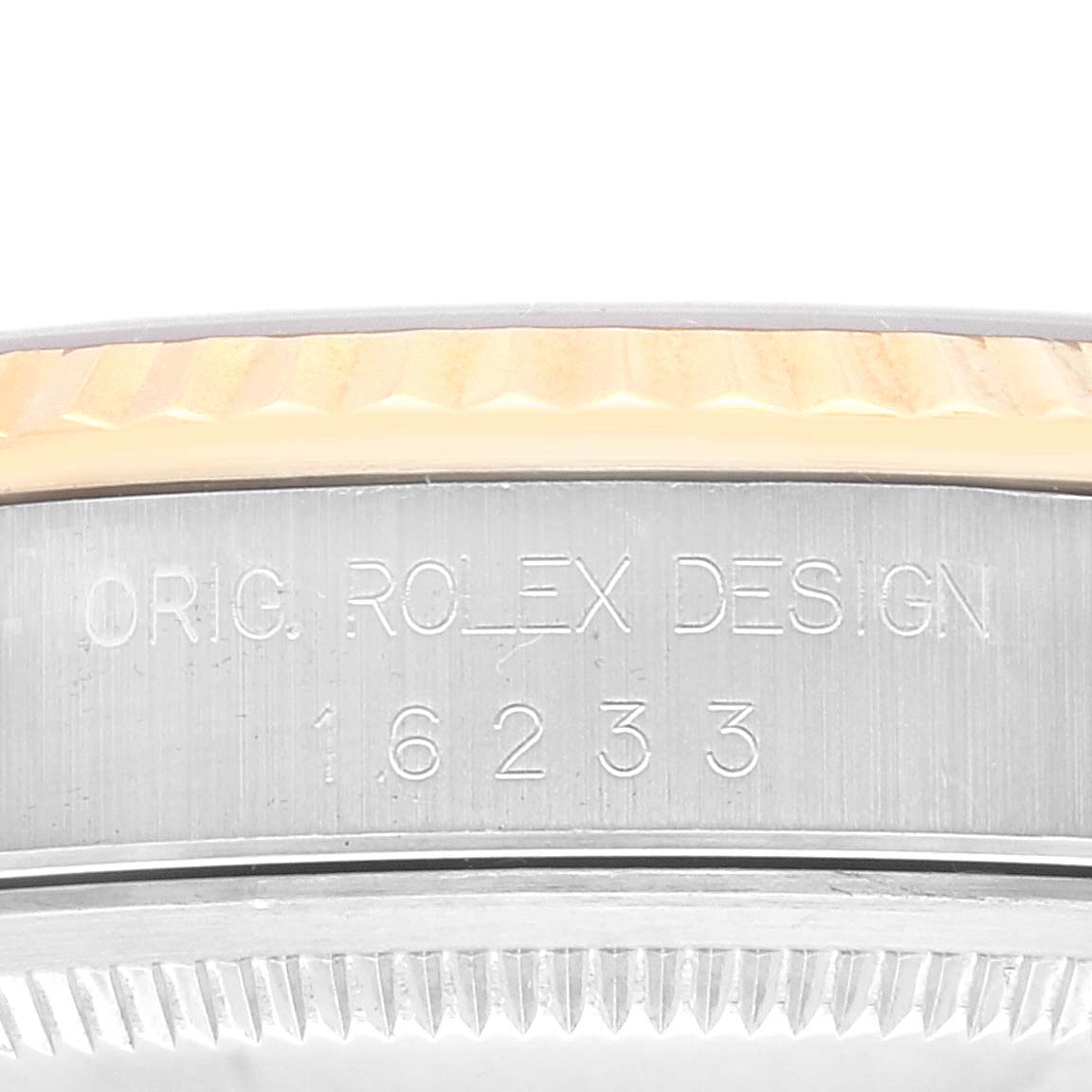 The image shows a close-up of the side of a Rolex Datejust 16233 Men's Steel and Gold (two tone) Champagne Dial 16233 Men's Steel and Gold (two tone) Champagne Dial watch, highlighting the engraved serial number and design details.