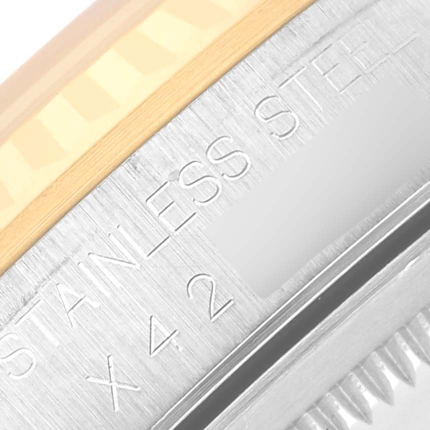 The image shows a close-up of the Rolex Datejust 16233 Men
s Steel and Gold (two tone) Champagne Dial 16233 Men
s Steel and Gold (two tone) Champagne Dial model
s brushed stainless steel edge and gold fluted bezel.