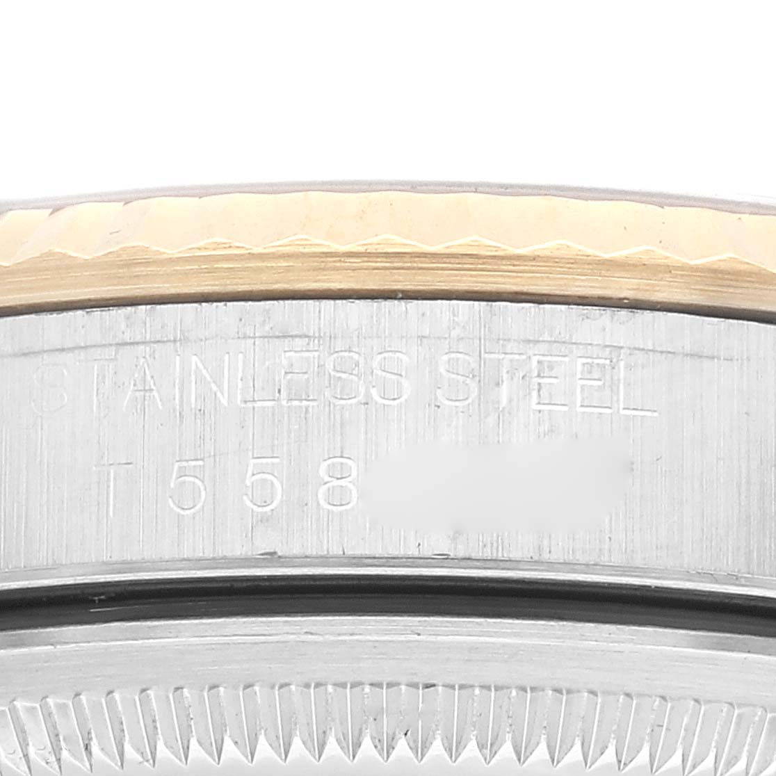 The image shows a close-up of the edge and bezel of a Rolex Datejust 16233 Men's Steel and Gold (two tone) Champagne Dial 16233 Men's Steel and Gold (two tone) Champagne Dial watch, highlighting the stainless steel markings.