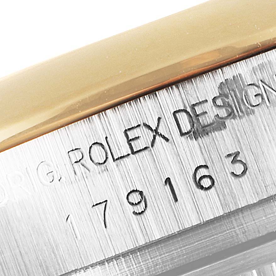 The image shows a close-up of the model number and "Rolex Design" engraving on the side of a Rolex Datejust 179163 Women
s Steel and Gold (two tone) Grey Dial 179163 Women
s Steel and Gold (two tone) Grey Dial watch.