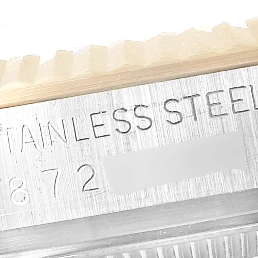 The image shows a close-up of the case side edge of a Rolex Vintage Collection 16013 Men's Steel and Gold (two tone) White Dial 16013 Men's Steel and Gold (two tone) White Dial model, highlighting the "STAINLESS STEEL" engraving.