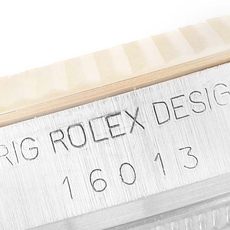 This image shows a close-up view of the etched serial number on the side of the bezel of a Rolex Vintage Collection 16013 Men's Steel and Gold (two tone) White Dial 16013 Men's Steel and Gold (two tone) White Dial model 16013.