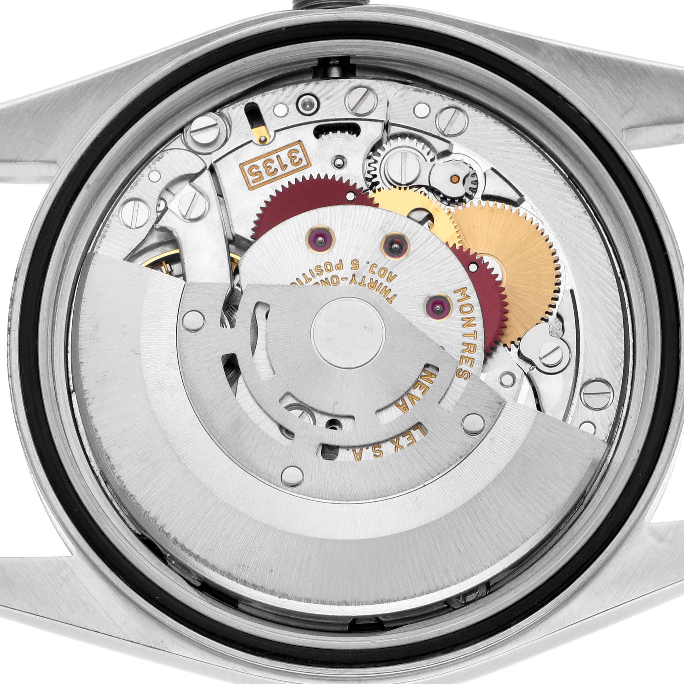 The image shows the back view of a Rolex Datejust 16233 Men
s Steel and Gold (two tone) White Dial, focusing on its intricate internal movement components.