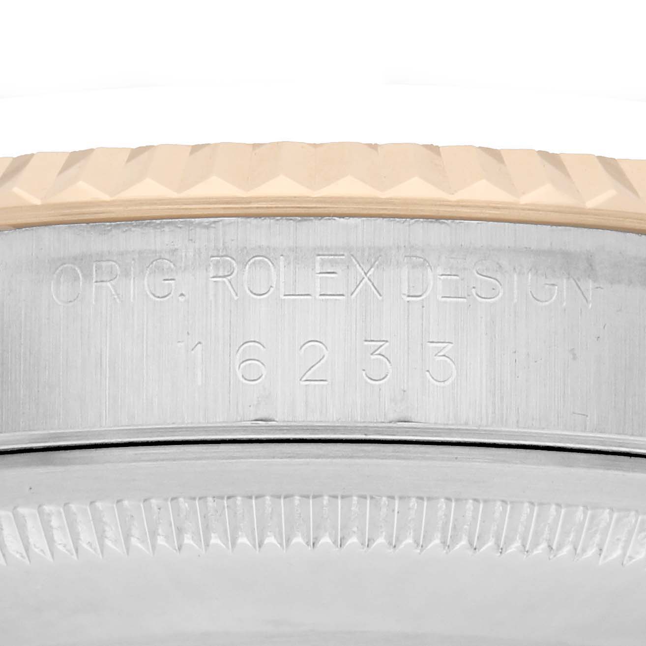 The image shows the side view of a Rolex Datejust 16233 Men
s Steel and Gold (two tone) White Dial model, displaying the case with engraved markings and the edge of the bezel.