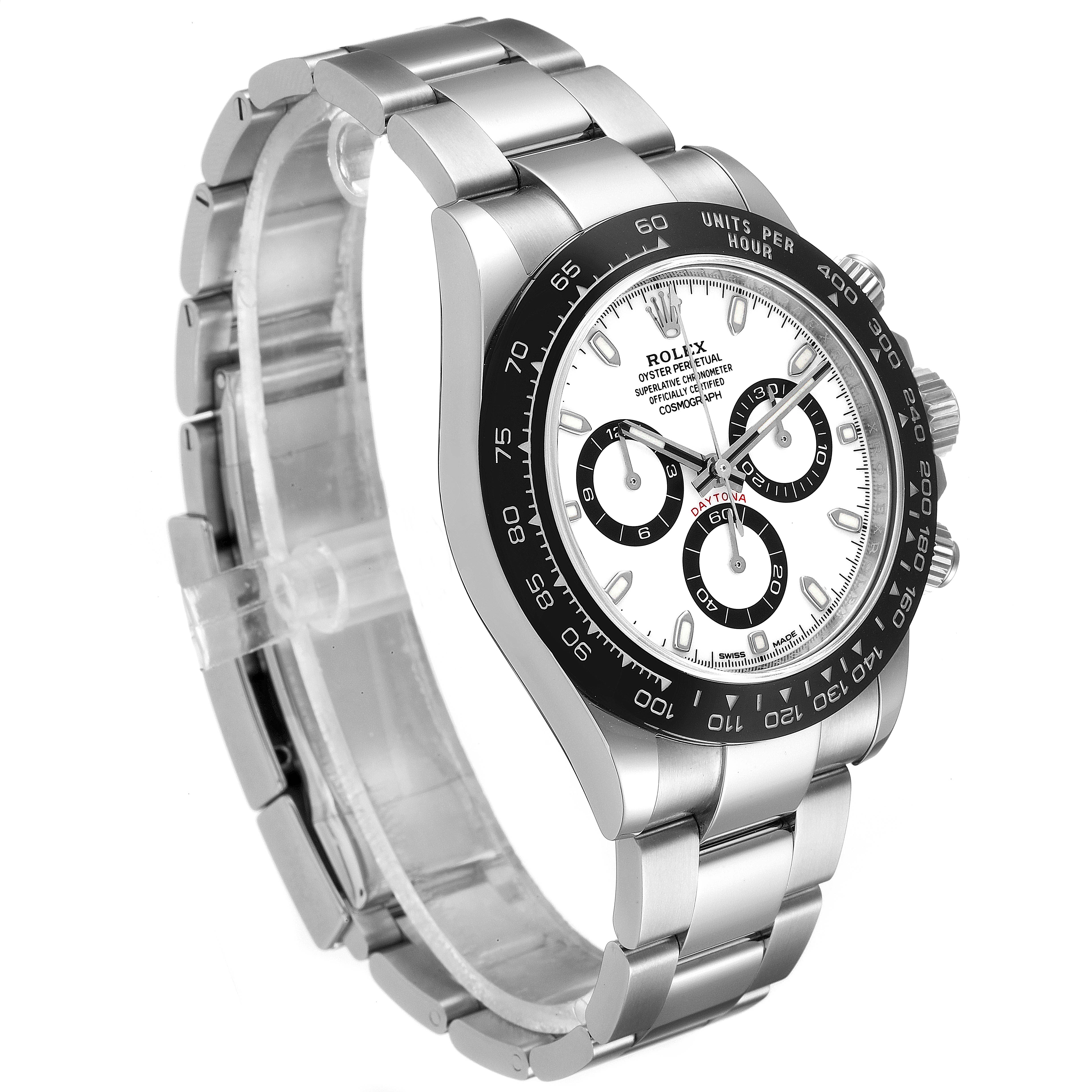 The image shows a Rolex Daytona 116500 Men
s Stainless Steel White Dial 116500 Men
s Stainless Steel White Dial watch from a three-quarter angle, highlighting its bezel, dial, and bracelet.