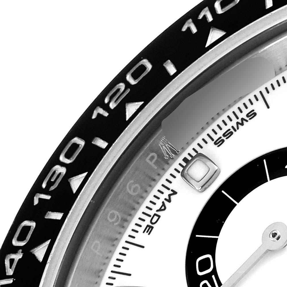 The image shows a close-up of the Rolex Daytona 116500LN Men's Stainless Steel White Dial 116500LN Men's Stainless Steel White Dial's bezel and part of the dial at an angle, highlighting the tachymetric scale.