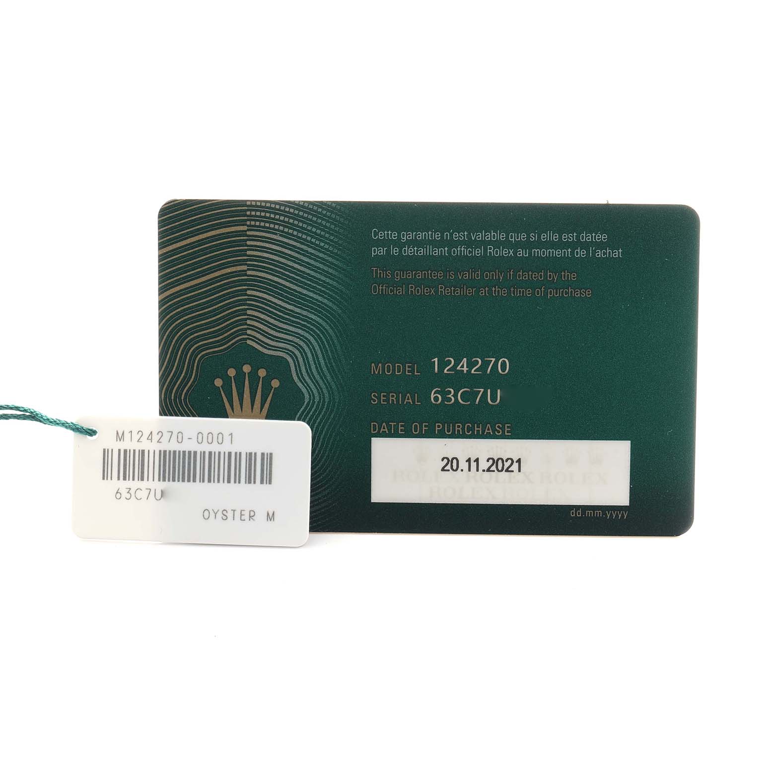 The image shows the warranty card and tag for a Rolex Explorer 124270 Men
s Stainless Steel Black Dial model 124270, featuring the serial number and purchase date.