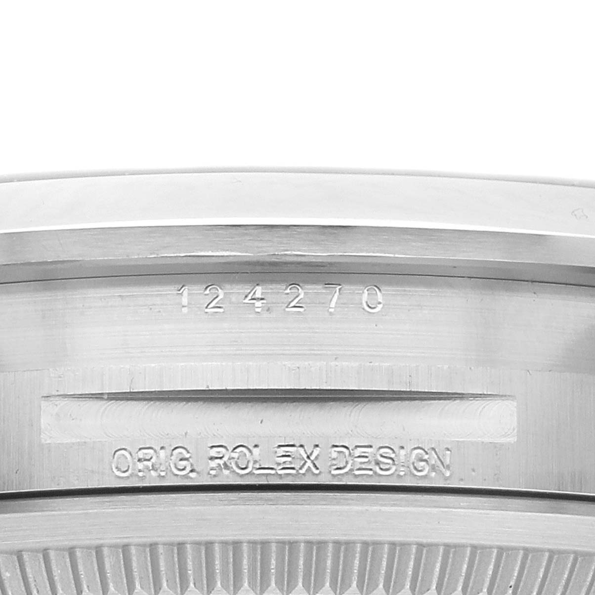 The image shows the side engraving on a Rolex Explorer 124270 Men
s Stainless Steel Black Dial, featuring the model number and "ORIG. ROLEX DESIGN."