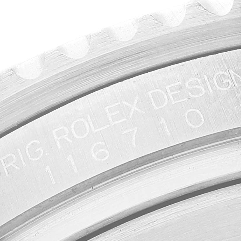 The image shows a close-up of the side engraving on the bezel of a Rolex GMT-Master 116710 Men
s Stainless Steel Black Dial 116710 Men
s Stainless Steel Black Dial watch, showcasing the Rolex serial number.