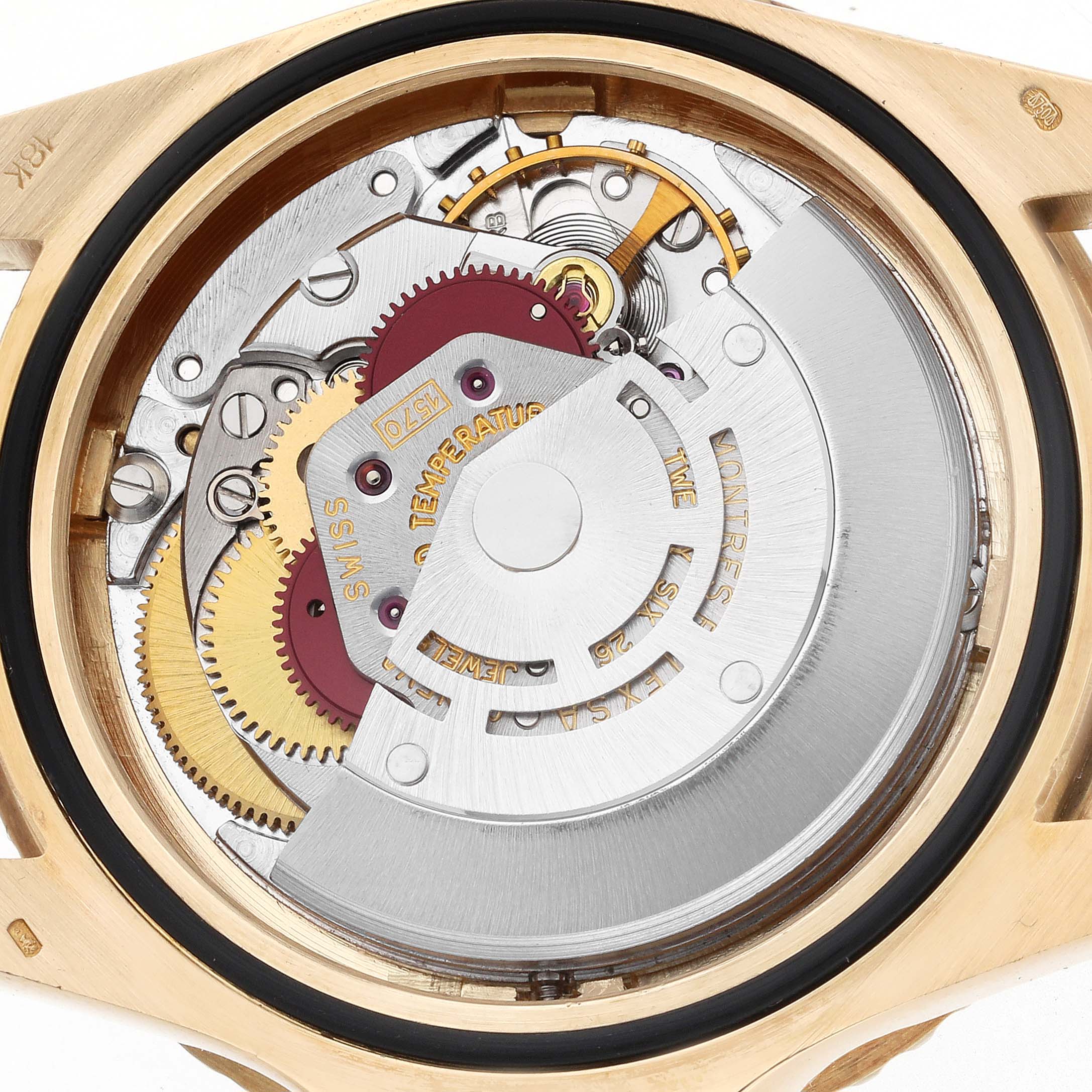 The image shows the movement mechanism of a Rolex GMT-Master 1675 Men
s Yellow Gold Brown Dial watch viewed from the back, highlighting gears and the rotor.