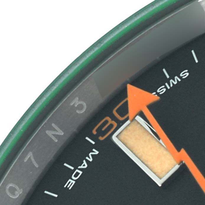The close-up angle shows the Milgauss model by Rolex with its orange lightning bolt hand and part of the dial.