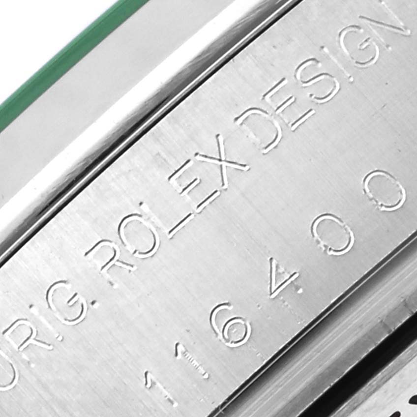 The image shows a macro shot of the Milgauss by Rolex, focusing on the engraved side of the case.