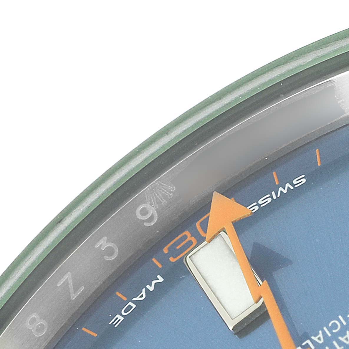 The image shows a partial view of the dial, bezel, and minute hand of a Rolex Milgauss 116400GV Men's Stainless Steel Blue Dial 116400GV Men's Stainless Steel Blue Dial watch at an angled close-up.