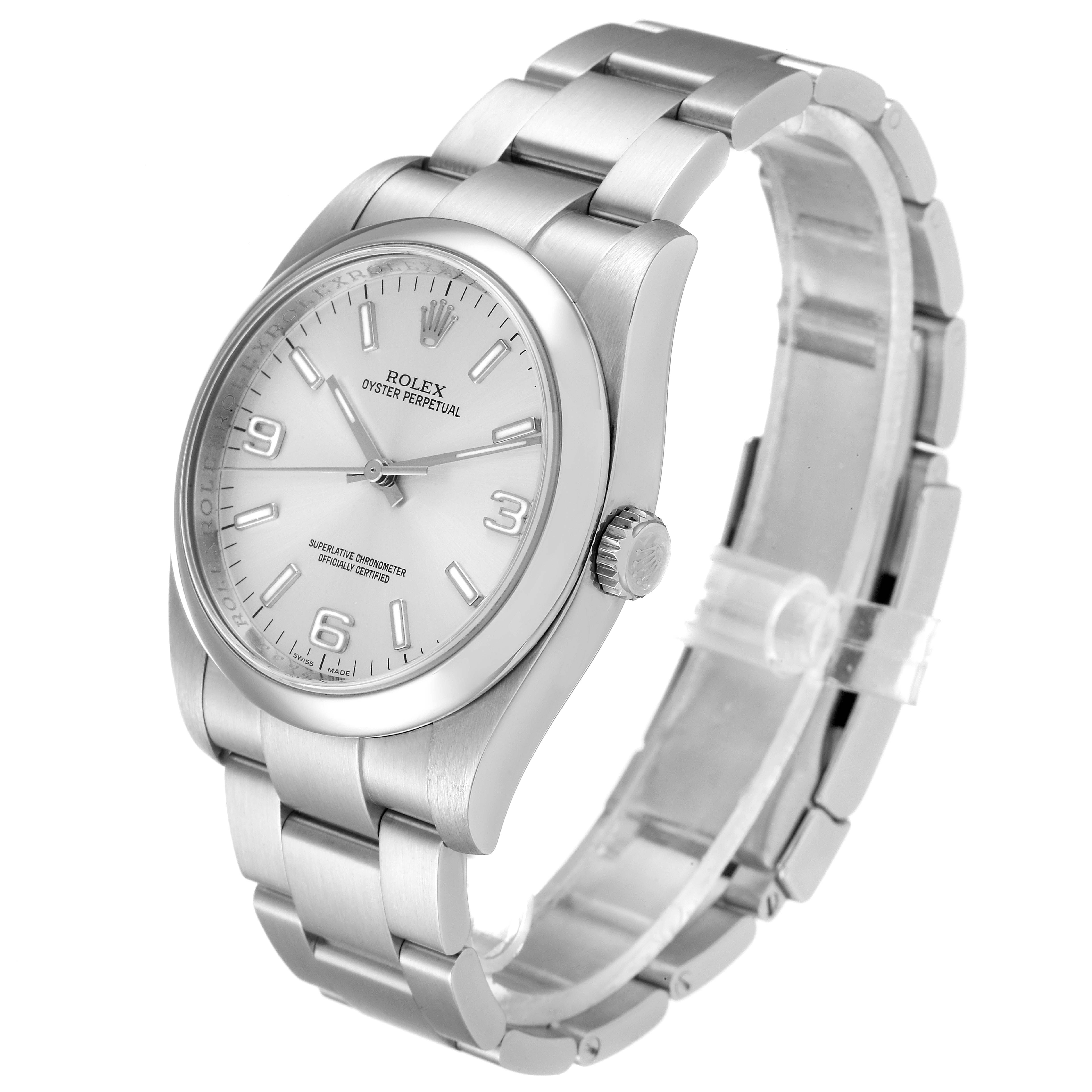 The Rolex Oyster Perpetual 116000 Men's Stainless Steel Silver Dial 116000 Men's Stainless Steel Silver Dial watch is shown from a front-left angle, highlighting its face, bezel, crown, and bracelet.