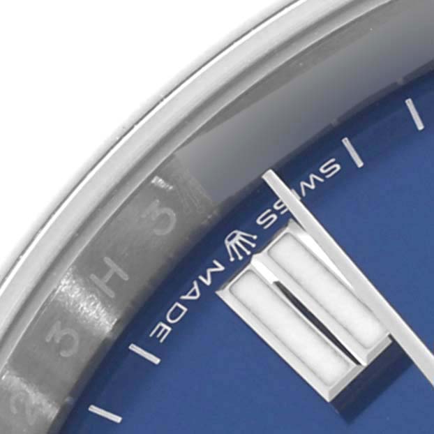 This close-up shows the dial and a portion of the silver rim of the Rolex Oyster Perpetual 126000 Men
s Stainless Steel Blue Dial 126000 Men
s Stainless Steel Blue Dial, highlighting the "Swiss Made" text.