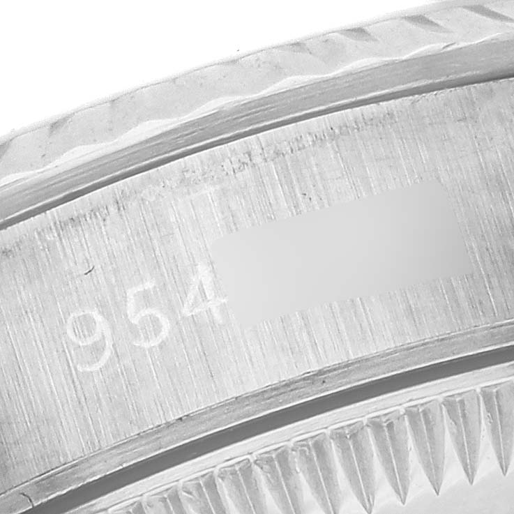 The image shows a close-up of the case edge and engraved serial number on a Rolex Oyster Perpetual 67194 Women's Stainless Steel White Dial 67194 Women's Stainless Steel White Dial watch.