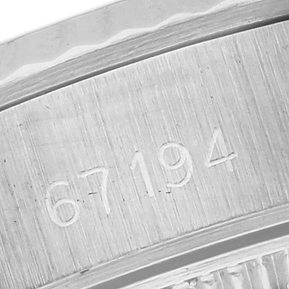 The image shows a close-up of the serial number engraved on the case of a Rolex Oyster Perpetual 67194 Women's Stainless Steel White Dial 67194 Women's Stainless Steel White Dial watch.
