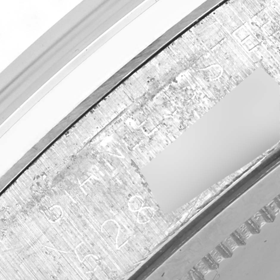 The image shows a close-up of the Rolex Vintage Collection 6694 Men's Stainless Steel Silver Dial 6694 Men's Stainless Steel Silver Dial's engraved watch case or bezel from a side angle.