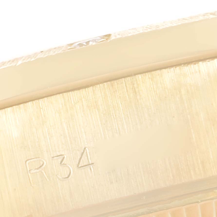 This image shows a close-up of the bracelet clasp of a Rolex President 69288 Women
s Yellow Gold Champagne Dial 69288 Women
s Yellow Gold Champagne Dial model watch, featuring the code "R34."