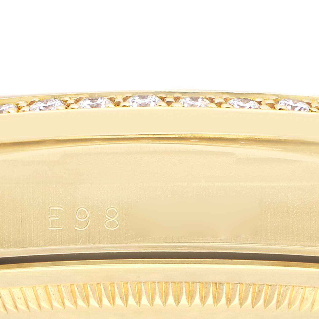 This image shows a close-up of the side of a bezel with diamonds, featuring a partial view of the case side of a Rolex President 18348 Men
s Yellow Gold Champagne Dial watch.